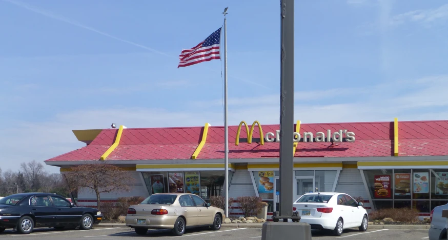 a car is parked in front of a mcdonald's restaurant