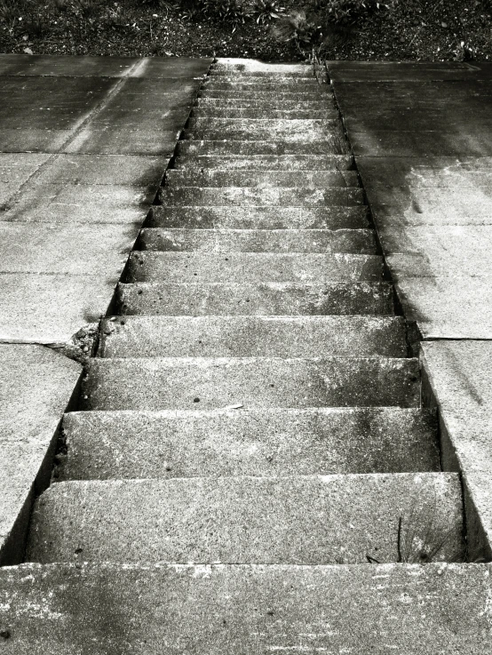 an old sidewalk has a set of steps in the middle