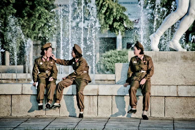 two people wearing military uniforms, one in red and the other in black