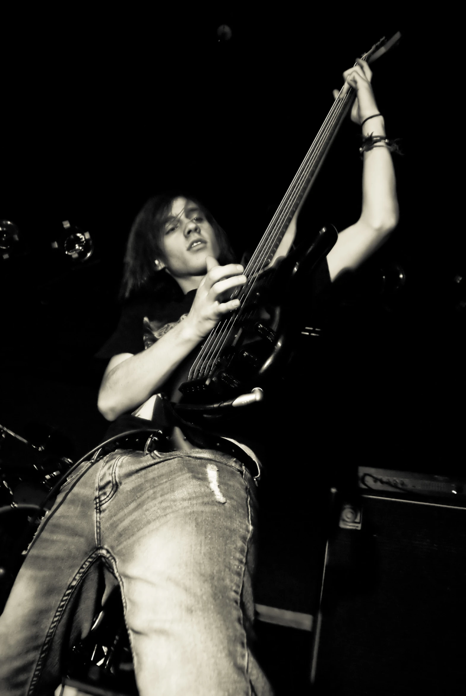 a man that is sitting down holding a guitar