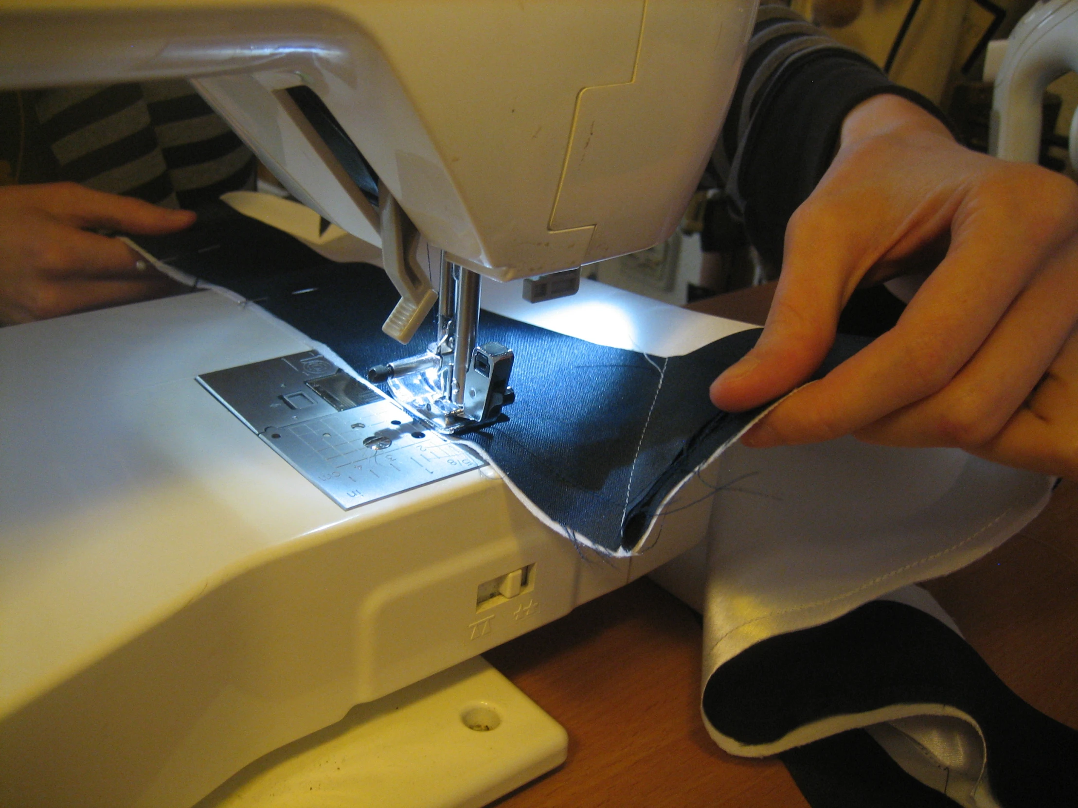 someone is using a sewing machine to sew