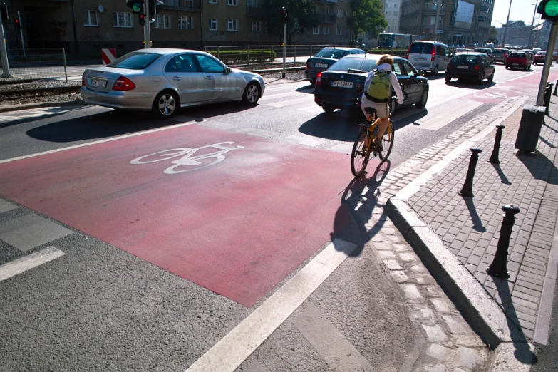 there is a bicyclist driving down the street