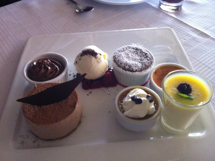 a small assortment of desserts on a serving platter