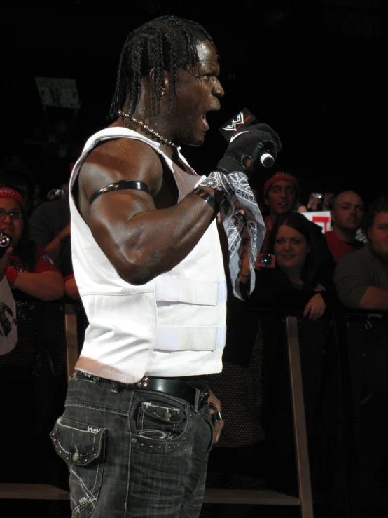 a man with dread locks is wearing his black and white shirt