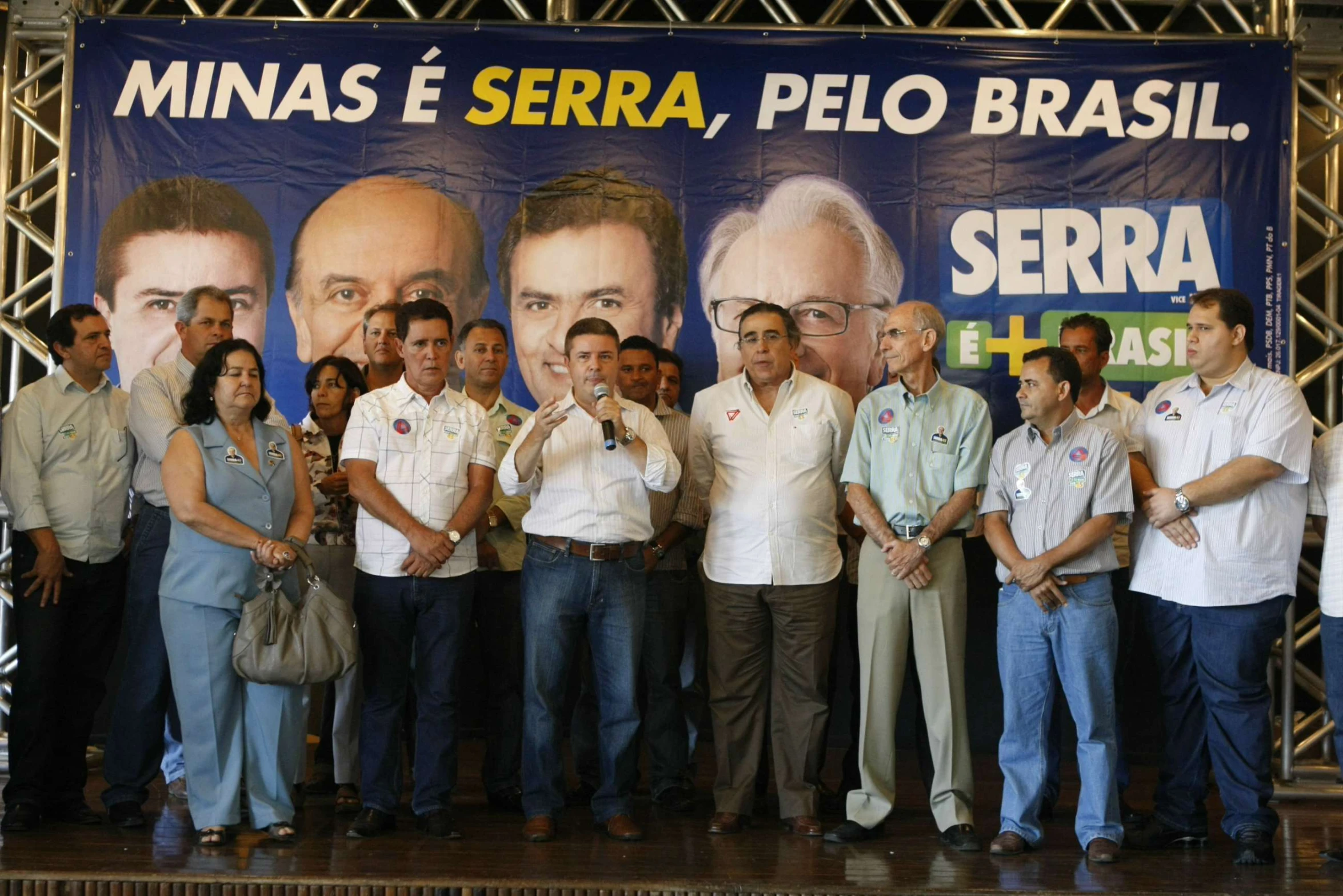 group of people standing in front of a movie poster