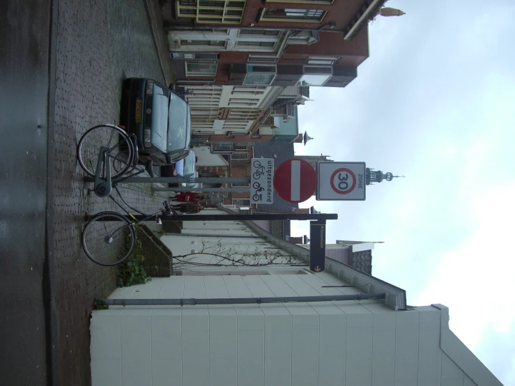 an image of a building sign and bicycles on the sidewalk