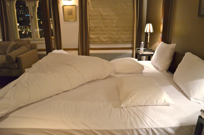 a bed is shown with several pillows on it