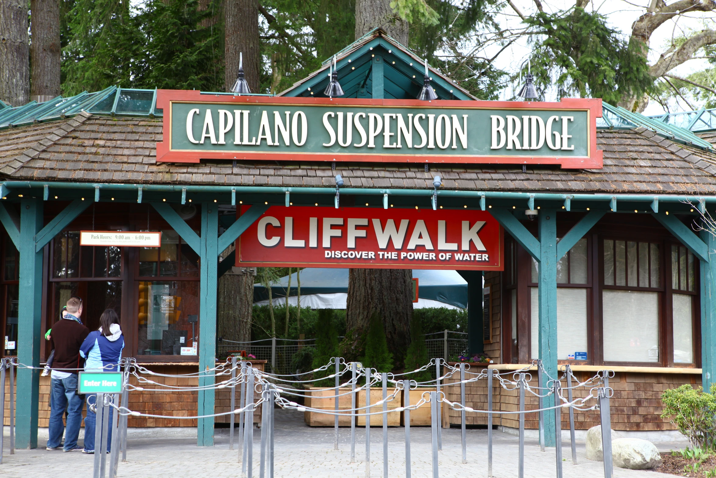 people standing outside the capel d sustension bridge