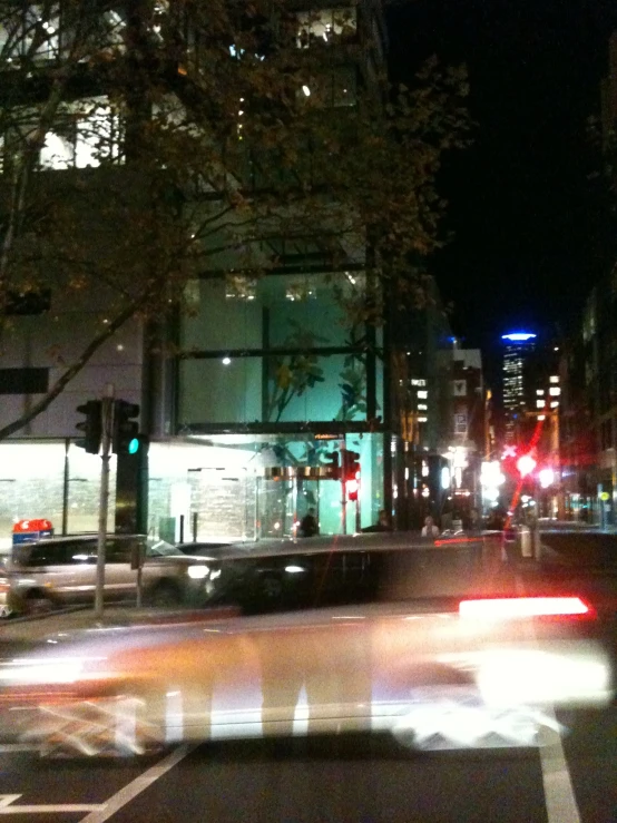 a city street with cars, trucks and a stoplight