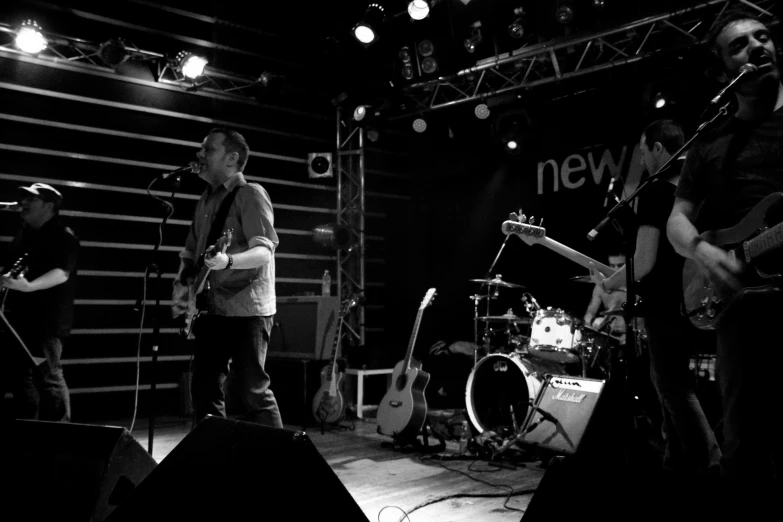 a group of men on stage with guitars