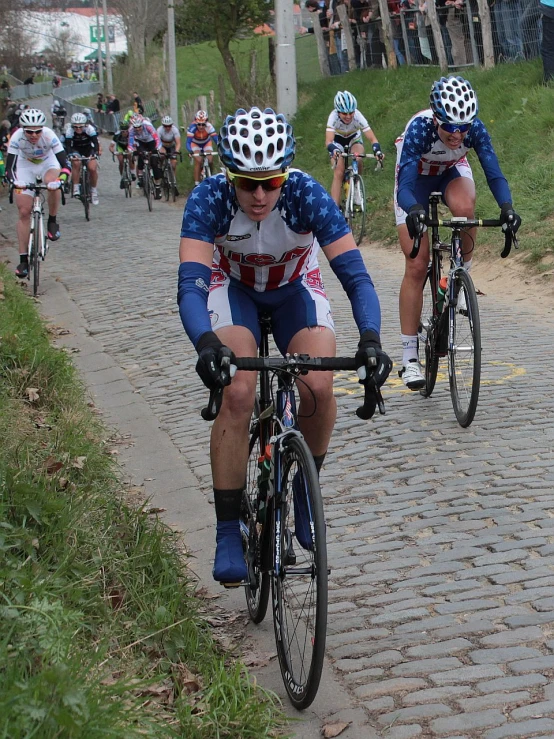 a group of cyclists racing down the road together