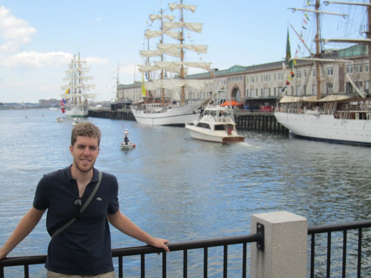 a man standing on a bridge next to a harbor