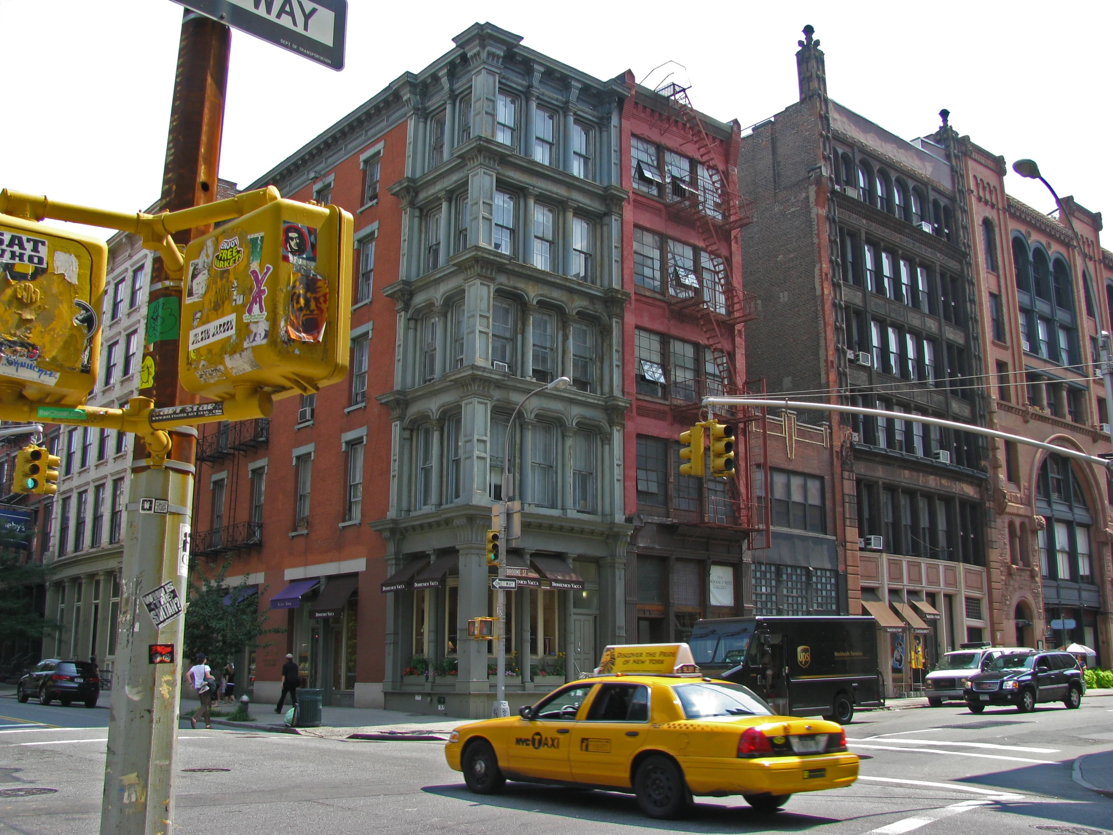 a taxi cab drives down a busy city street