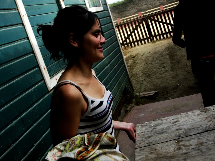 a girl wearing a  shirt on a porch