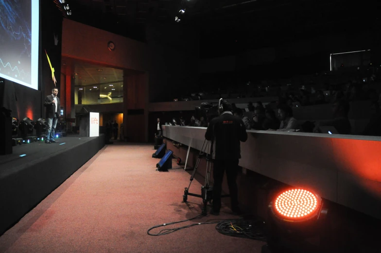 audience at a panel of a presentation on stage