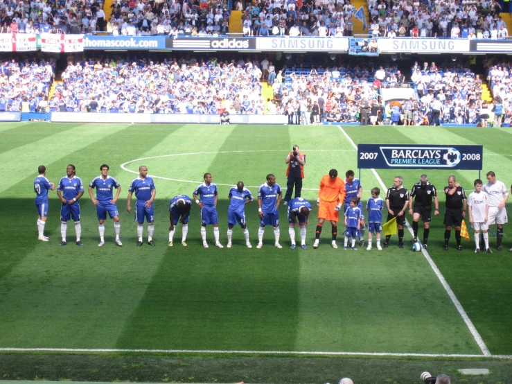 a large group of men on a soccer field