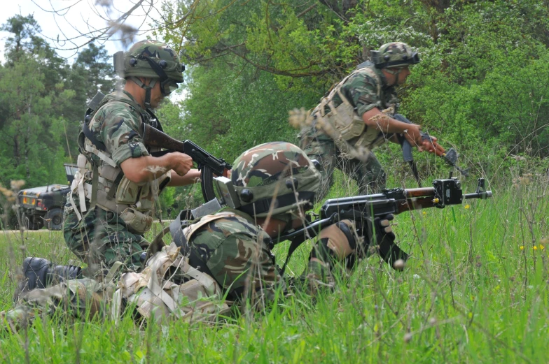 a few men with rifles and an army vehicle