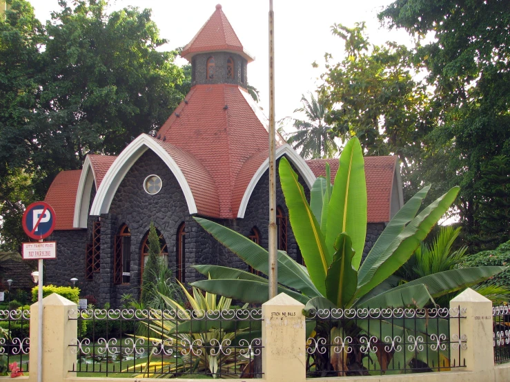 a picture of a church behind the fence