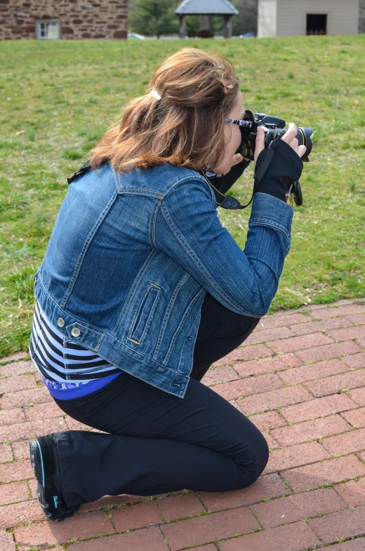 a girl is sitting down holding her camera