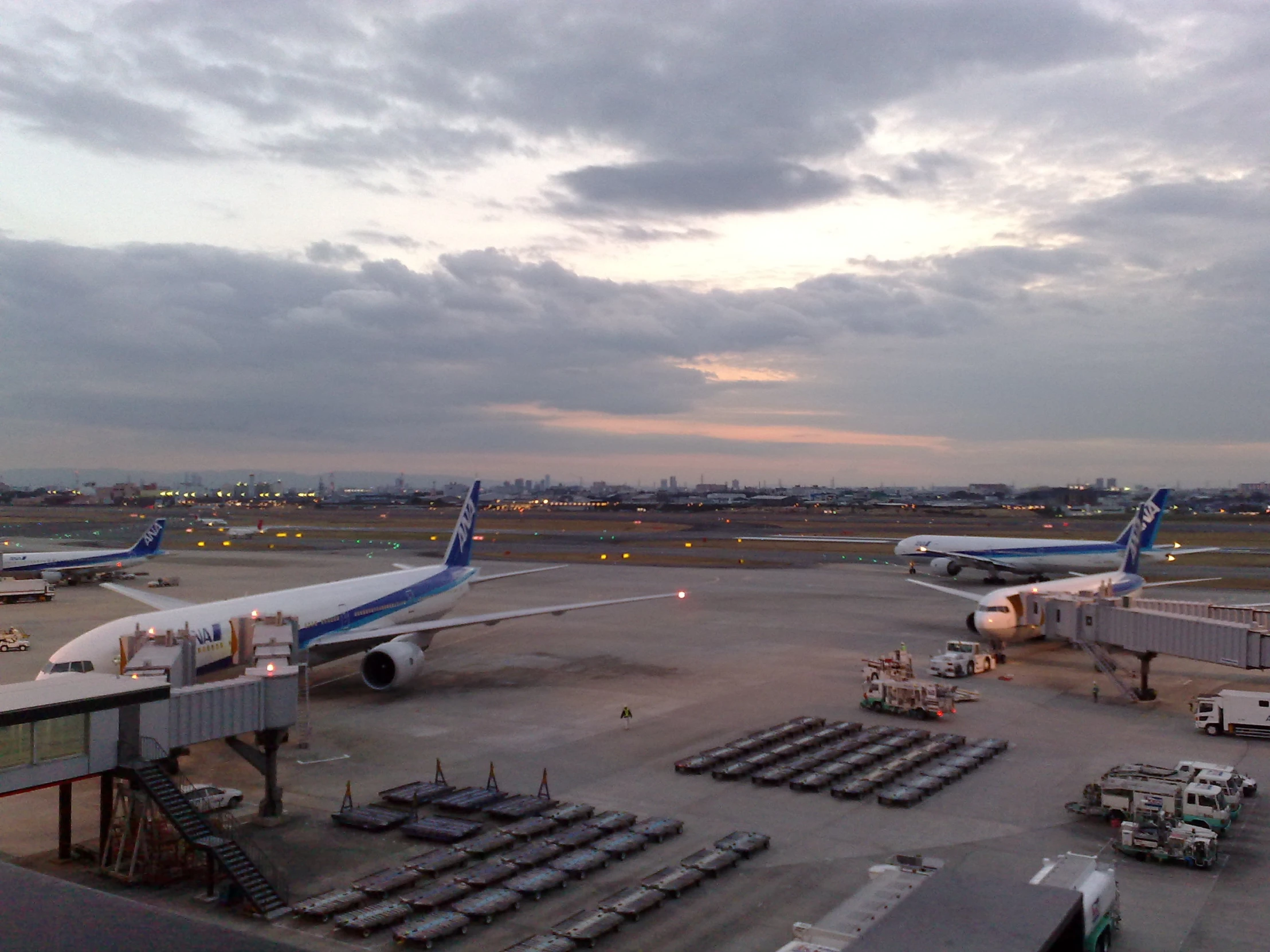 an air port with a few planes at the gates