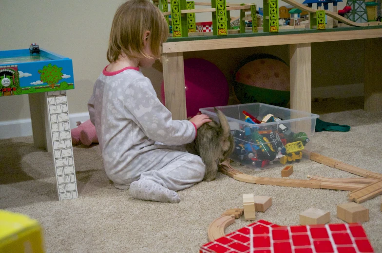 a child playing with his toys in the living room