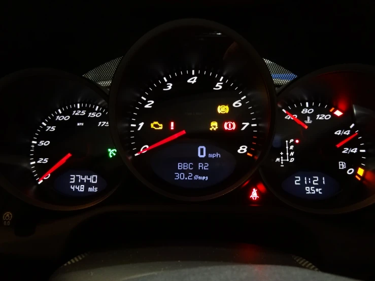 a close up of three gauges on a vehicle