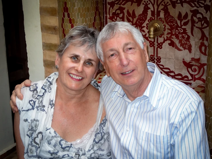 an older man and an old woman posing for a picture