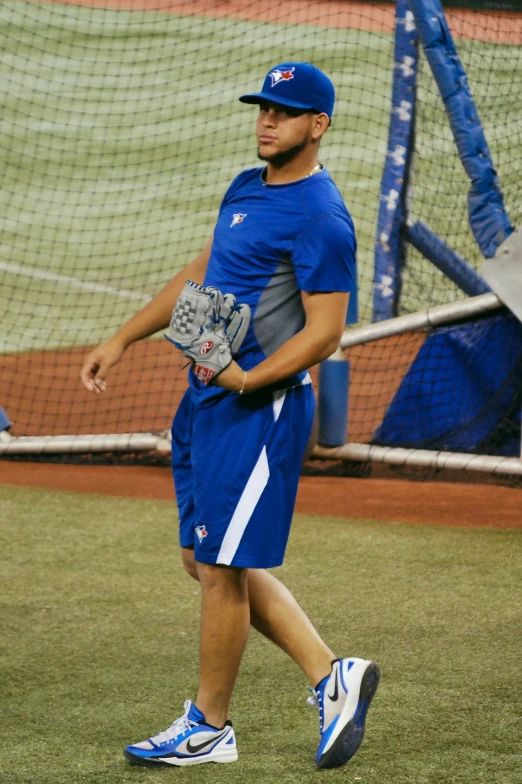 a professional baseball player is walking in a field