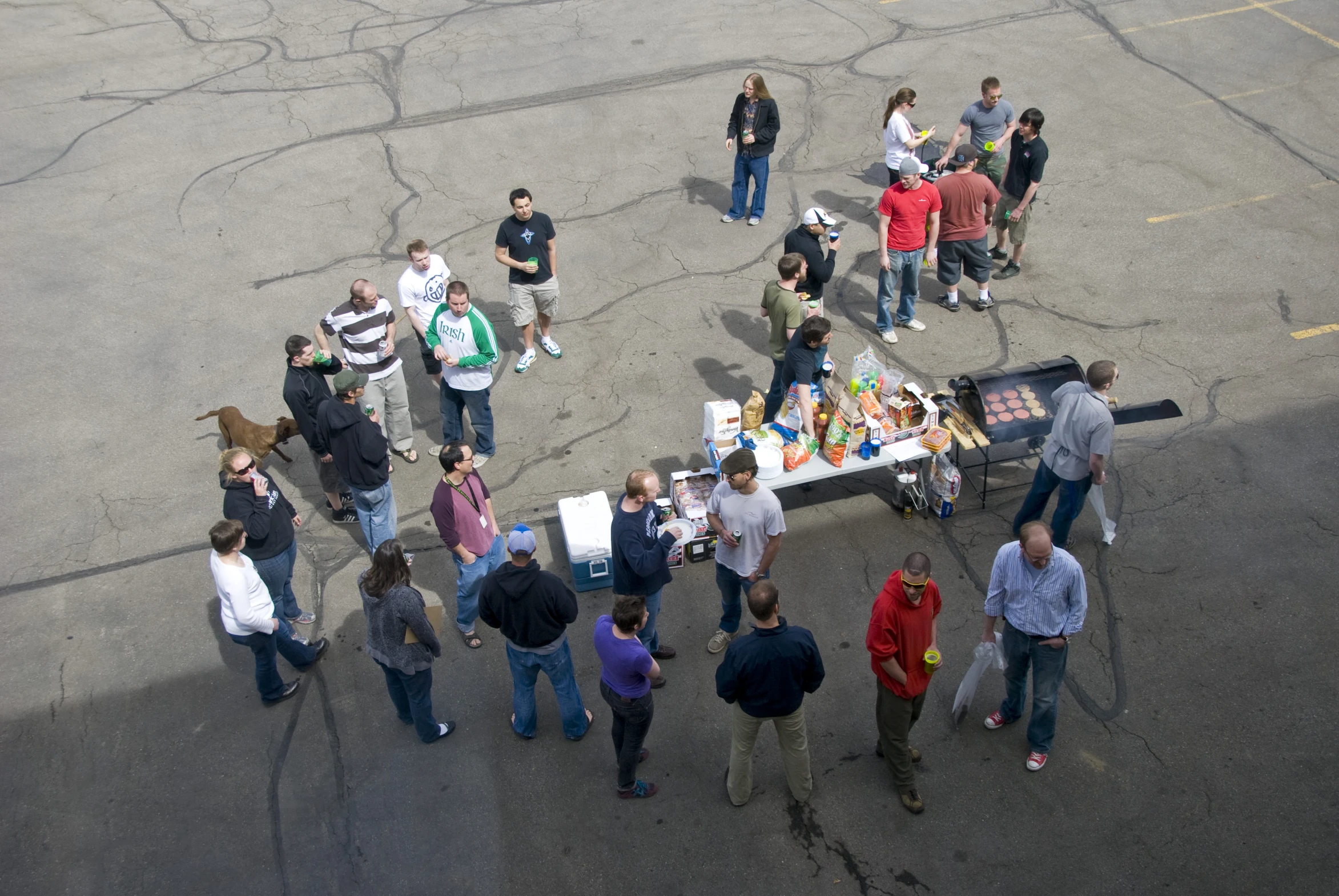 a group of people gather around a table with a small amount of food