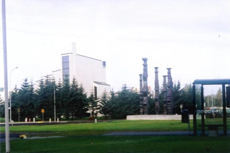 the exterior view of the building behind a row of trees