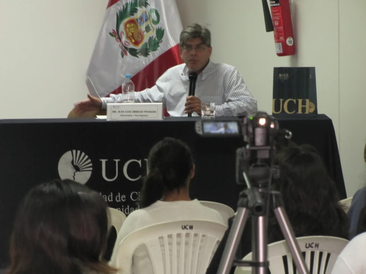 a man speaking on stage at a press conference