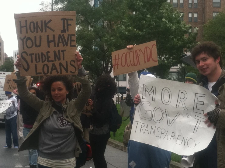 a group of young people holding up signs