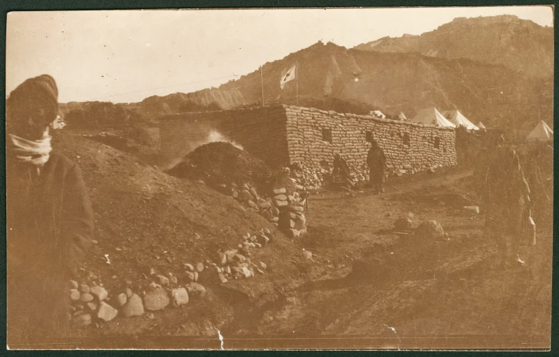 a vintage po of rocks and buildings on a hill