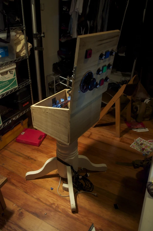 a wooden chair sits on the floor next to other clutter