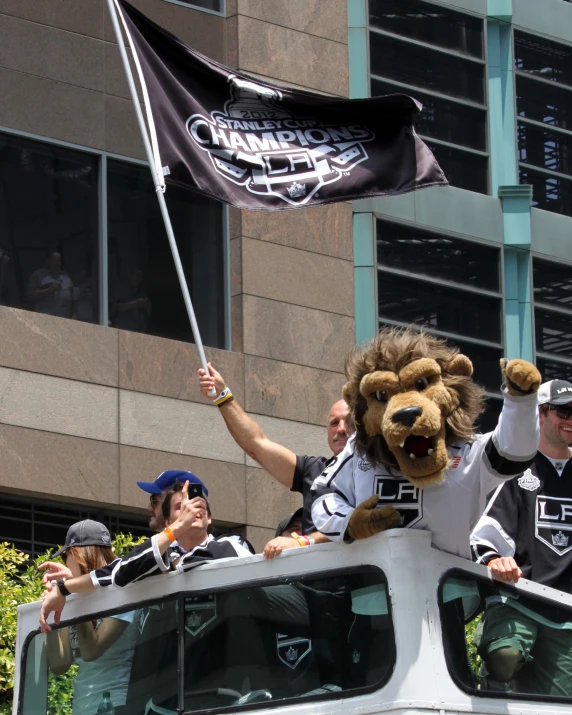 several people in uniforms on a float behind a van