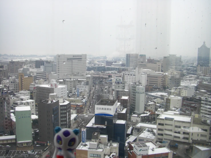 a stuffed animal sitting on top of a window sill