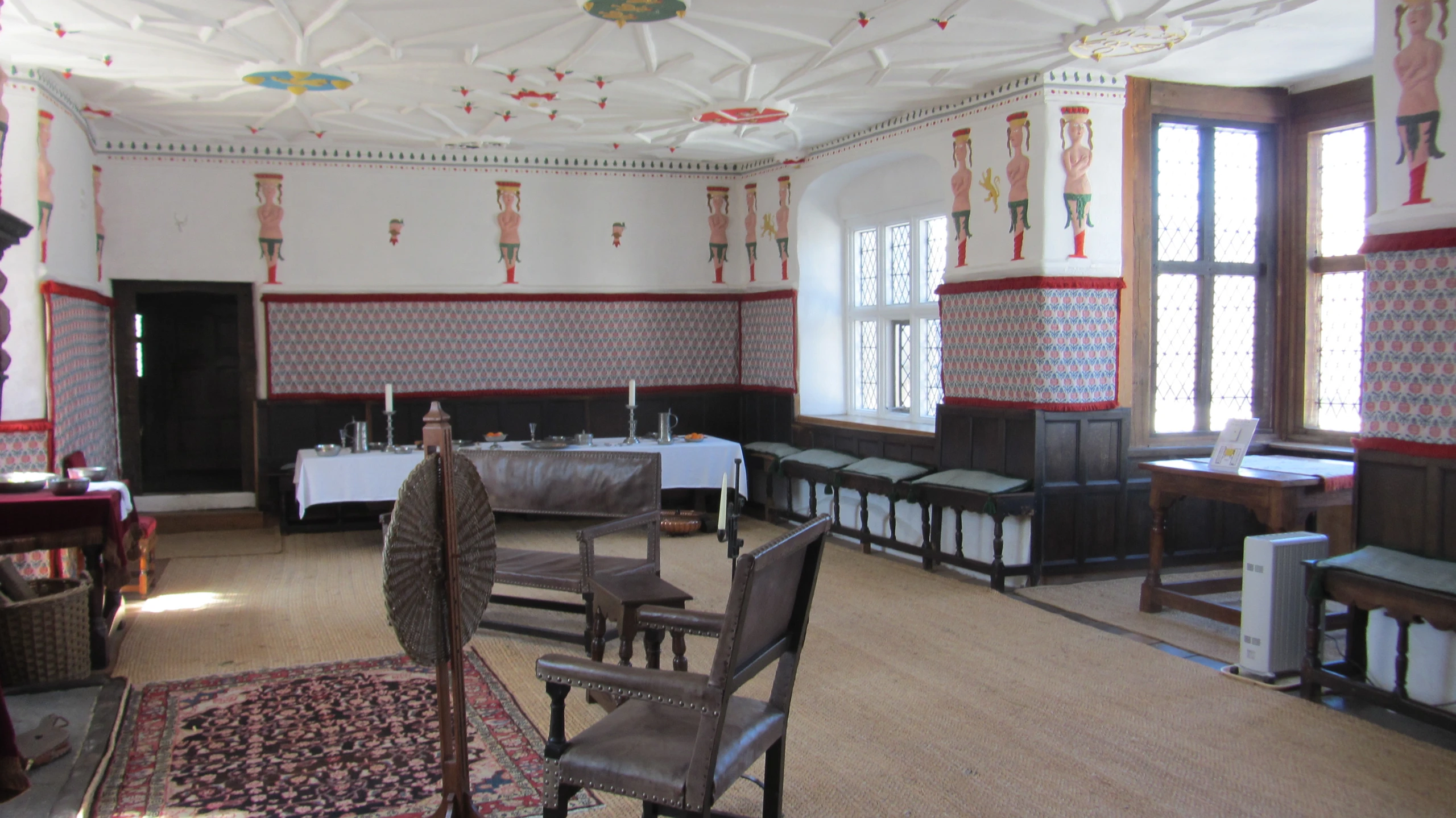 an old dining room that is decorated in old furniture