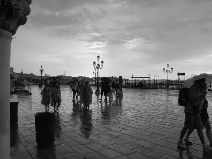 a group of people walking down a street carrying umbrellas