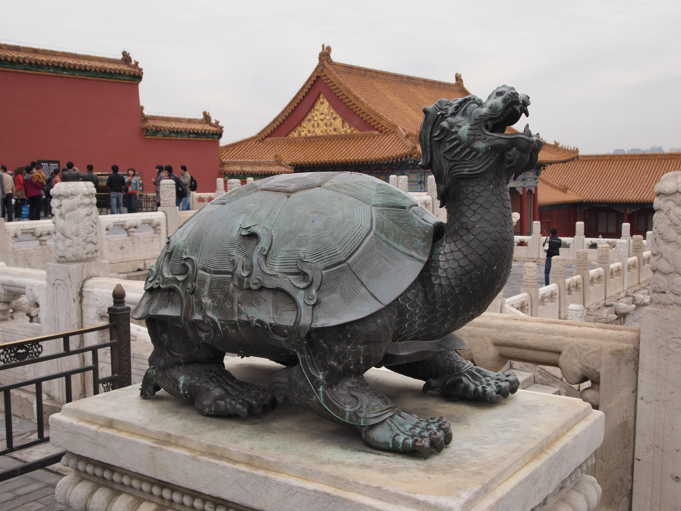 a sculpture of a camel stands in front of a chinese building
