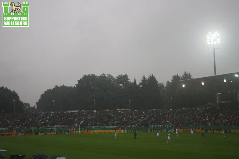 a soccer stadium full of people watching the game