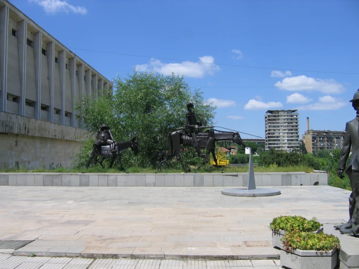 statues of people riding horses in the background