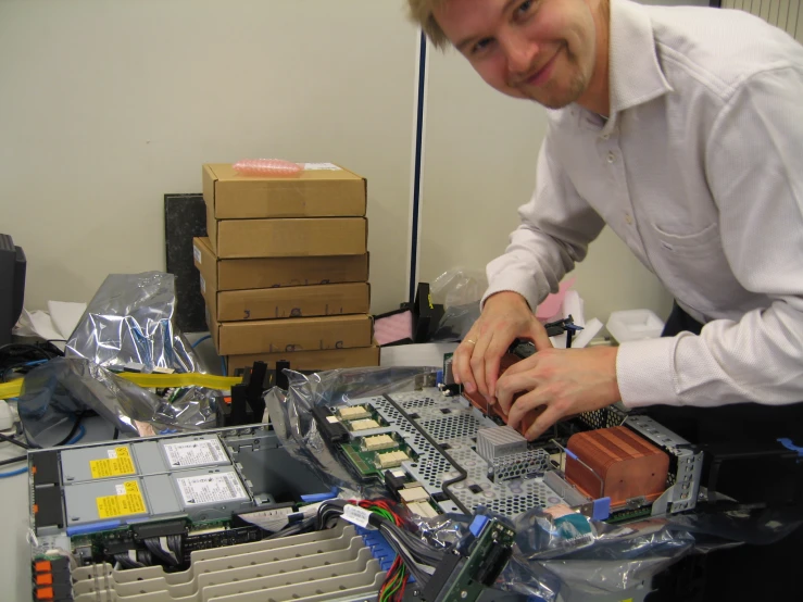 a man is working on a piece of electronics