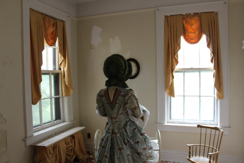 woman standing in room with furniture and window