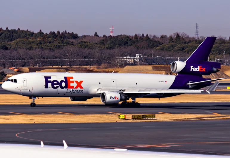 a large fedex airplane on the runway