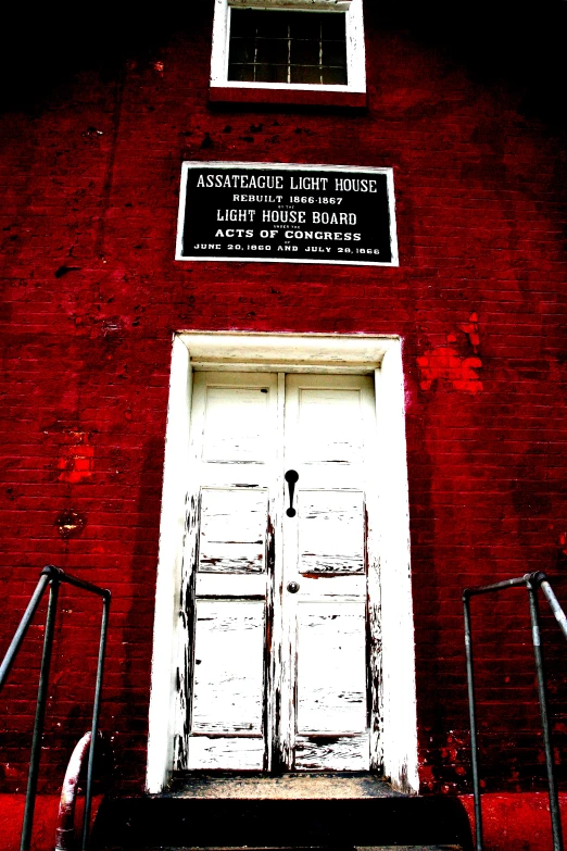 an image of red brick building with white doors