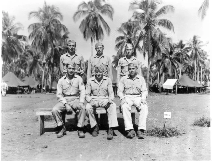 a group of men sitting next to each other on a bench