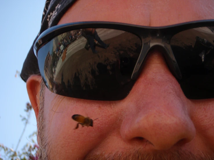 a man with mirrored shades, a beard and glasses