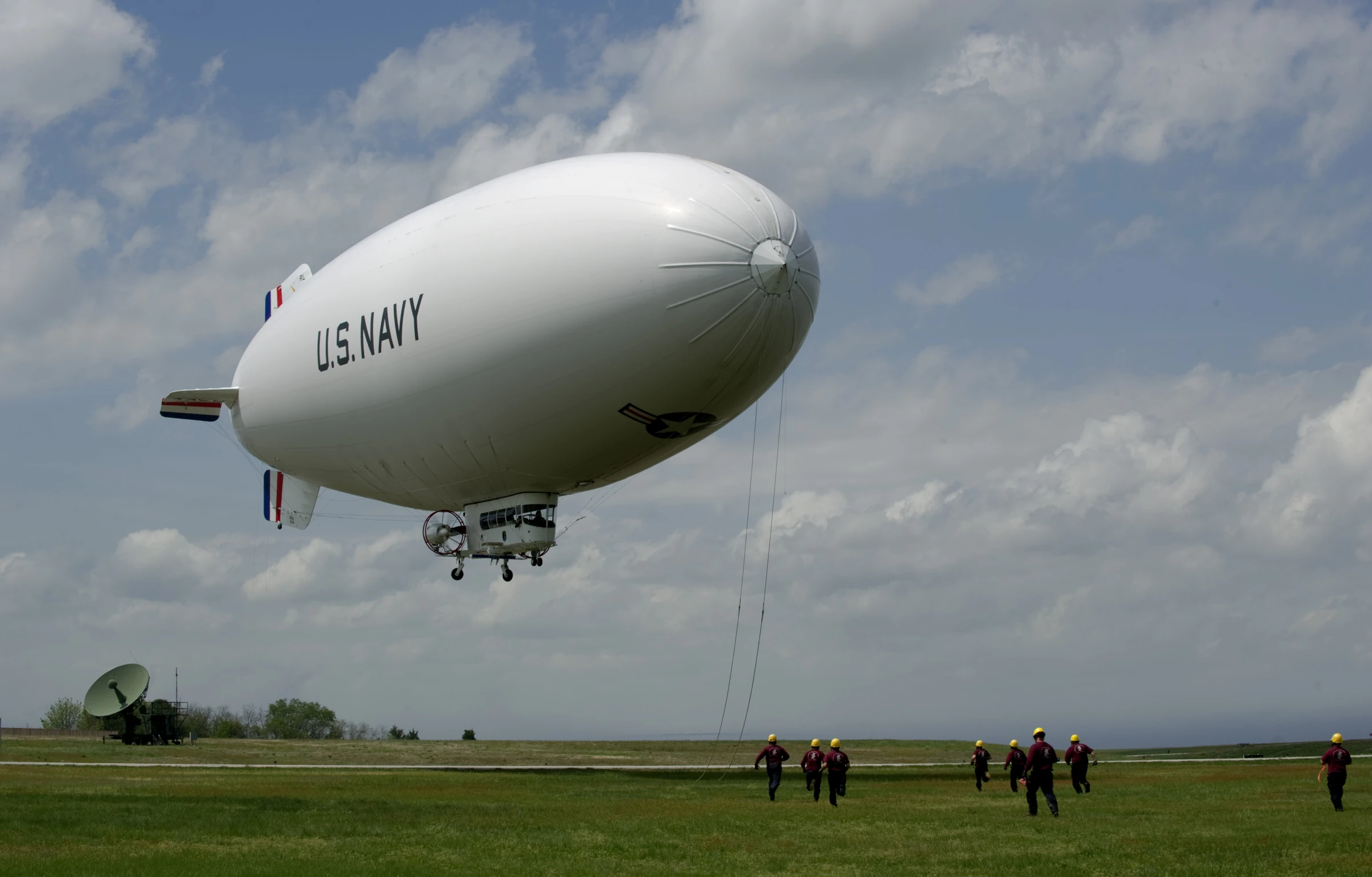 large white air plane with the word us navy attached to the wings