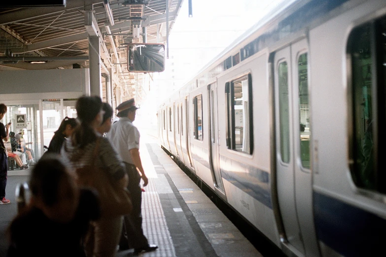 people standing near train in train station on platform