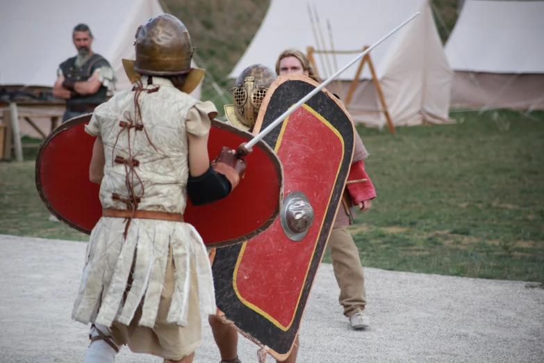 two people in historical costumes in a field